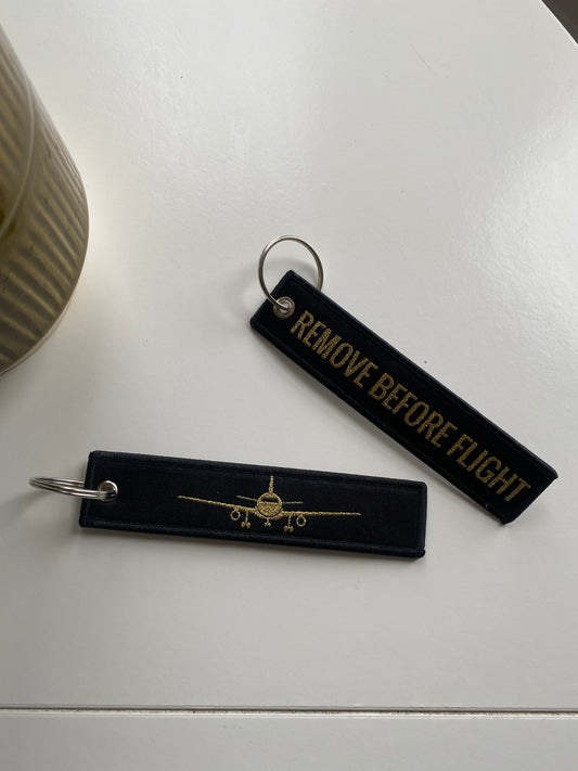 Black remove before flight luggage tag