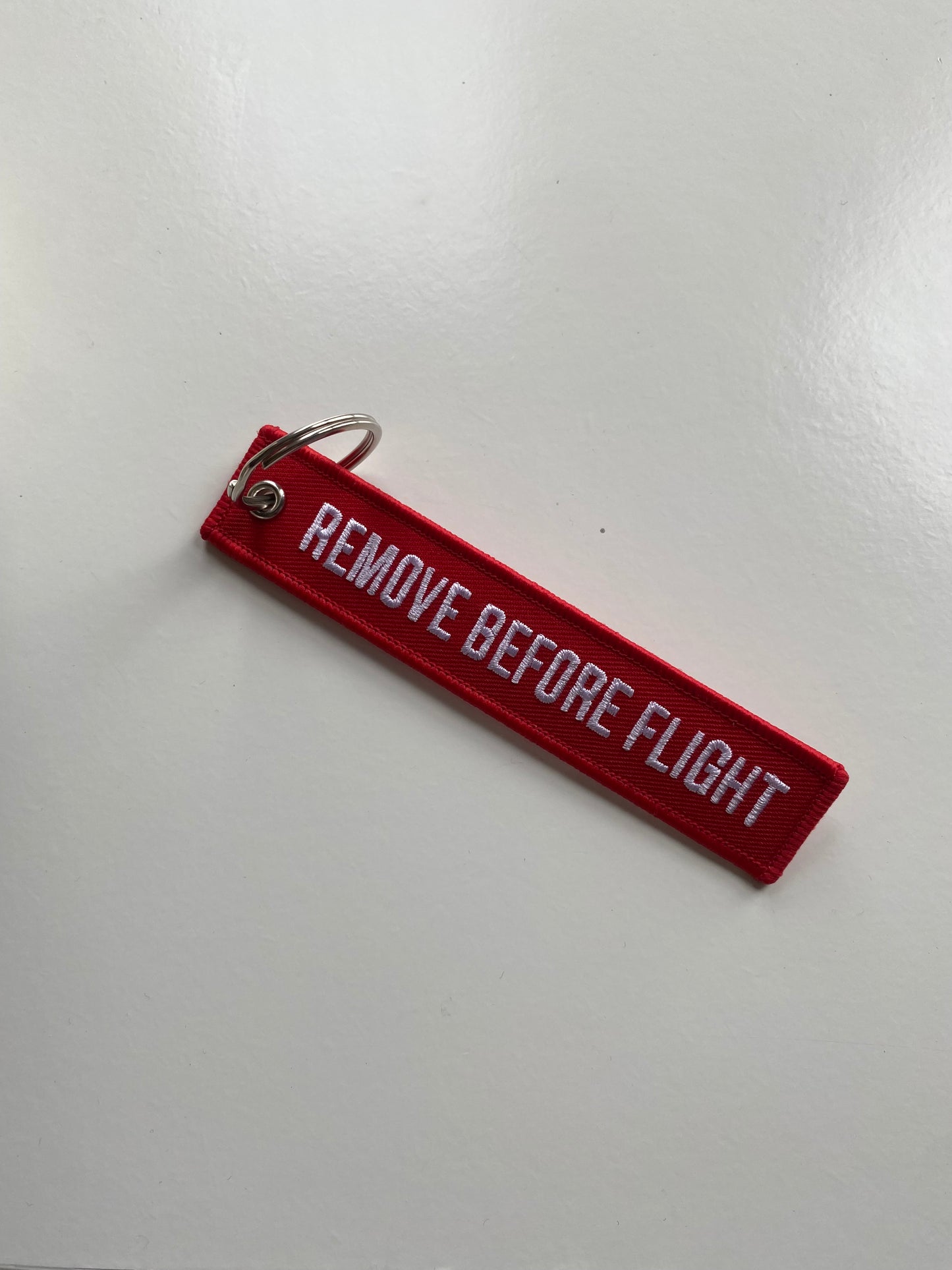 Red remove before flight luggage tag