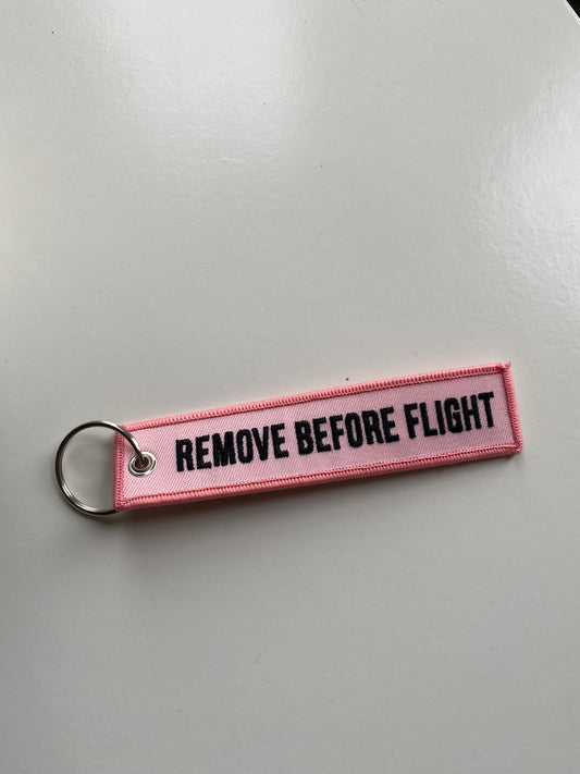 Pink remove before flight luggage tag