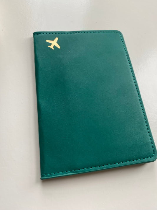 Green passport cover with gold plane detail